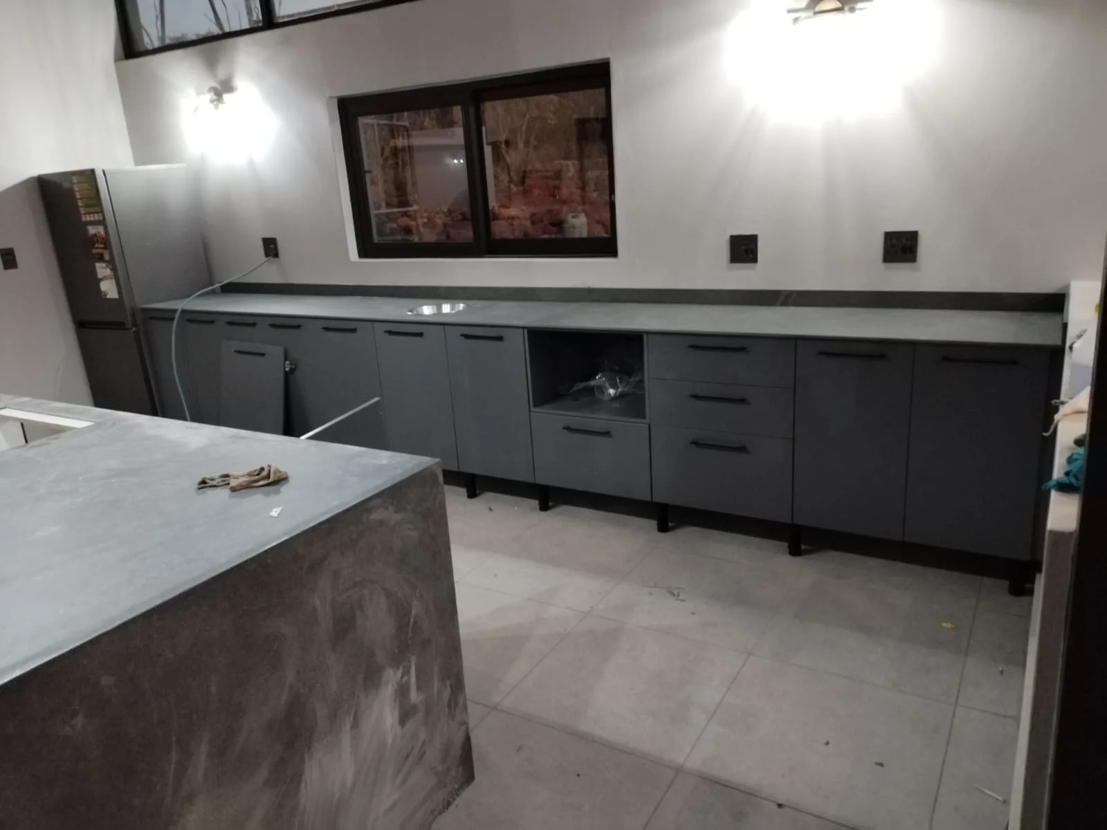 Charcoal kitchen cupboards and fitted countertop by Z J Ceiling and Kitchen Masters