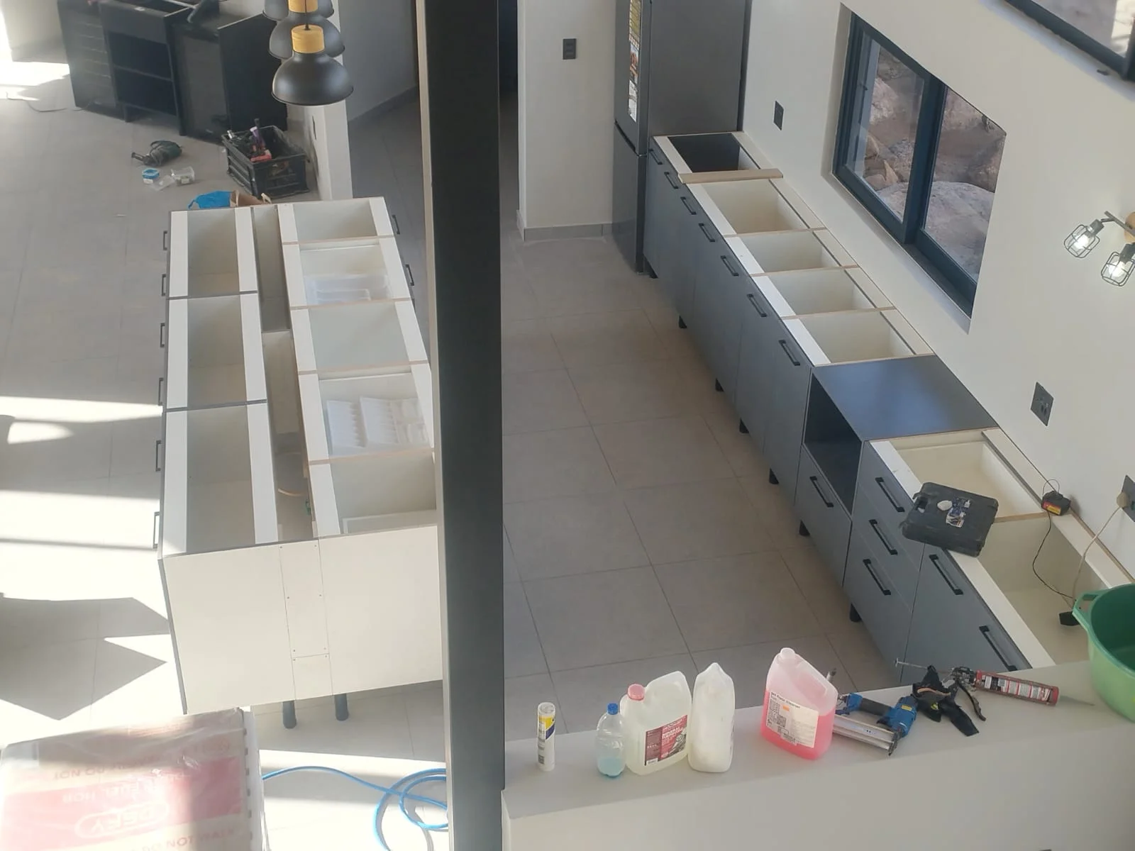 Kitchen carcasses before countertop fitting by Z J Ceiling and Kitchen Masters
