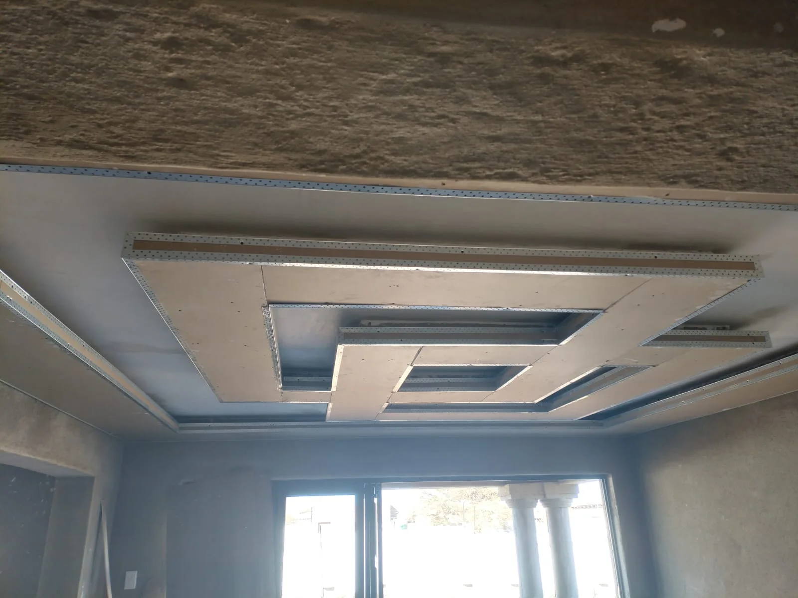 Geometric bulkhead framing by Z J Ceiling and Kitchen Masters